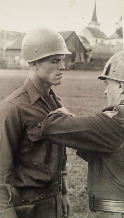 Maj. Gen. E. N. Harmon awards the distinguished service cross to S/Sgt. Rex D. Clark
